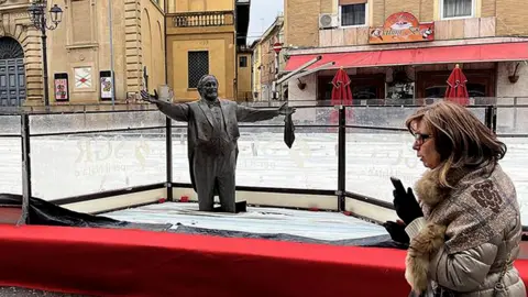 Pavarotti's Statue Encased in Ice: A Misguided Tribute in Pesaro